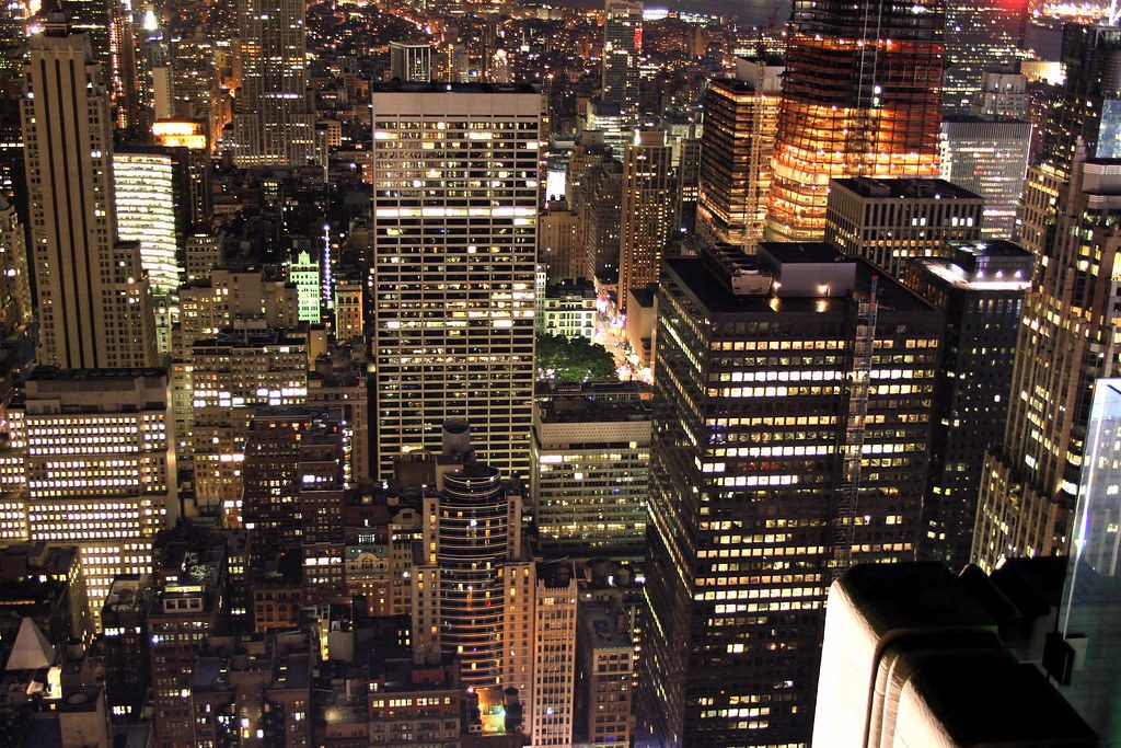 City skyline at night glowing under a bright orange haze