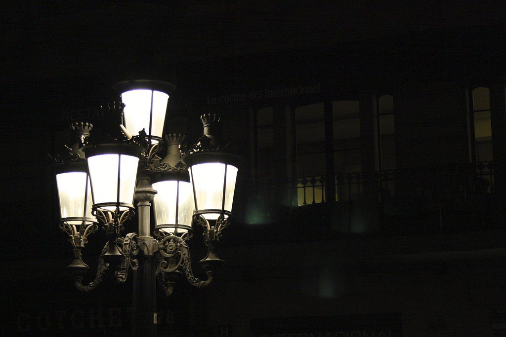 Street lamp glowing brightly against a dark night sky