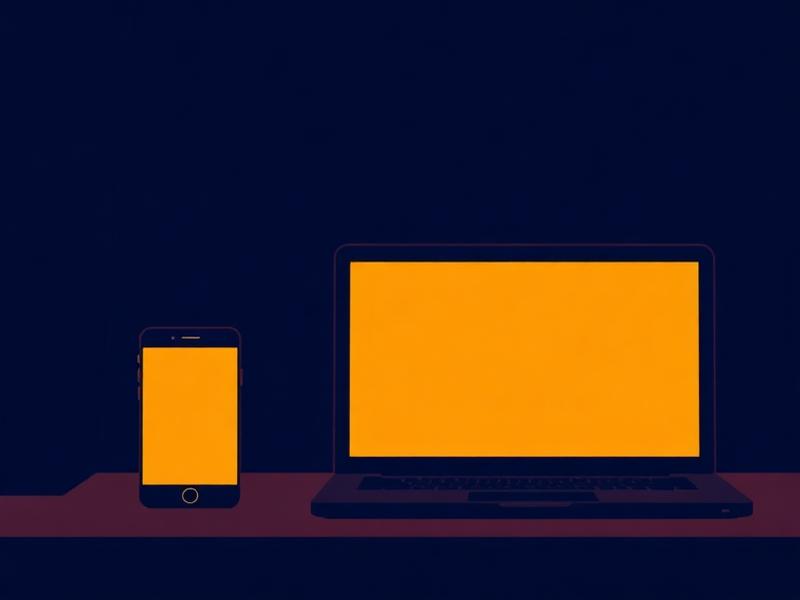 Phone and laptop screens glowing dim warm amber in a dark room